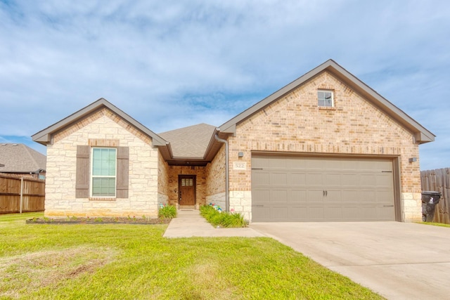 522 N Montague St, Pilot Point, TX 76258 - view of front of property with driveway, brick siding, stone siding, and an attached garage
