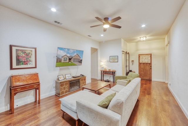522 N Montague St, Pilot Point, TX 76258 - living room with ceiling fan, light wood-style floors, recessed lighting, a barn door, and baseboards