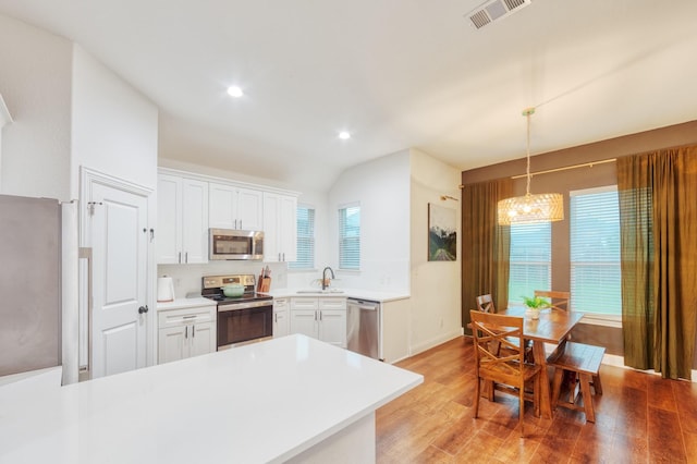 522 N Montague St, Pilot Point, TX 76258 - kitchen with appliances with stainless steel finishes, a sink, light wood-style flooring, white cabinets, and light countertops