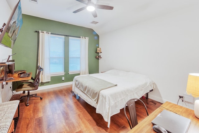 522 N Montague St, Pilot Point, TX 76258 - bedroom featuring wood finished floors, an office area, vaulted ceiling, baseboards, and a ceiling fan
