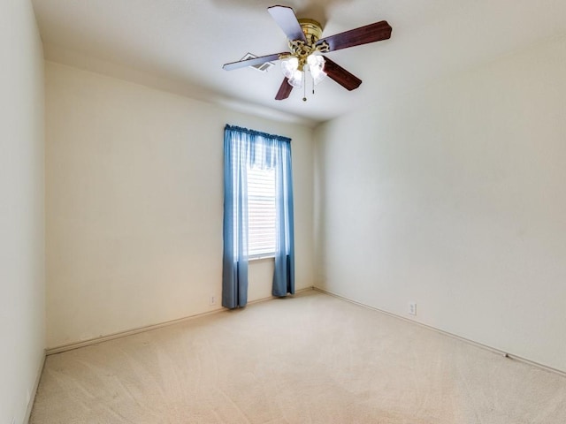 carpeted spare room with ceiling fan