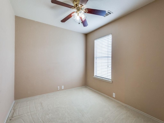 empty room featuring carpet floors, plenty of natural light, baseboards, and a ceiling fan