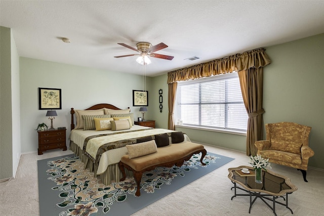 carpeted bedroom with ceiling fan and baseboards