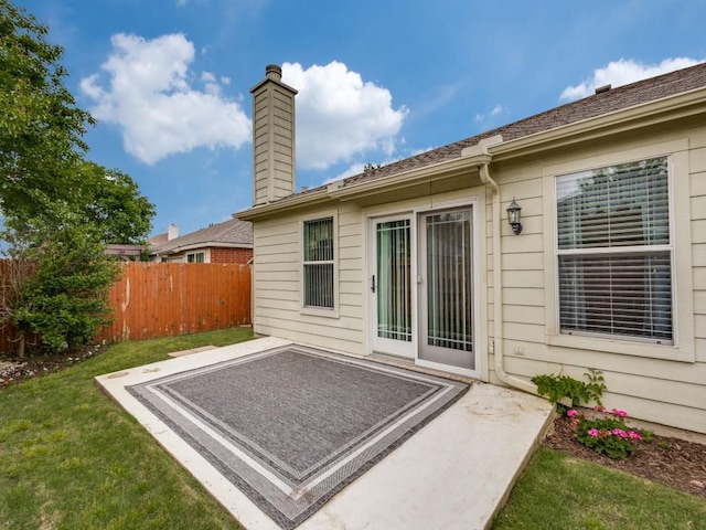 rear view of house with a patio area and a chimney