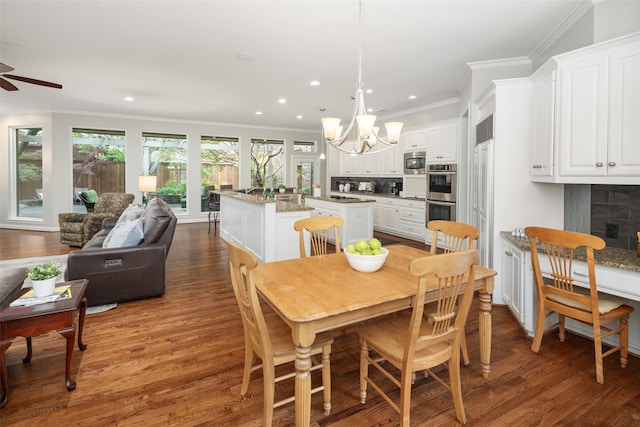 dining room featuring a ceiling fan, a chandelier, wood finished floors, ornamental molding, and recessed lighting