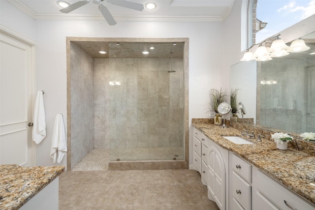 bathroom with a tile shower, vanity, ceiling fan, ornamental molding, and recessed lighting