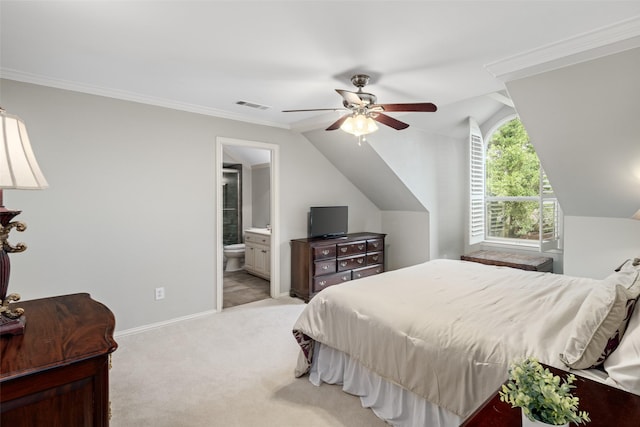 bedroom featuring light carpet, vaulted ceiling, ensuite bathroom, baseboards, and ceiling fan
