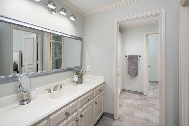 bathroom featuring ornamental molding, vanity, a shower with shower door, toilet, and baseboards