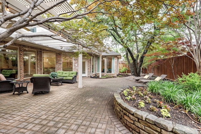 view of patio / terrace featuring outdoor lounge area and fence