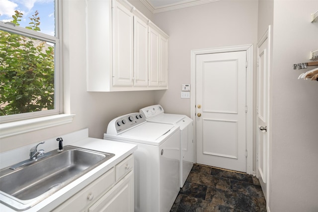 clothes washing area featuring cabinet space, separate washer and dryer, dark stone finish floors, and crown molding
