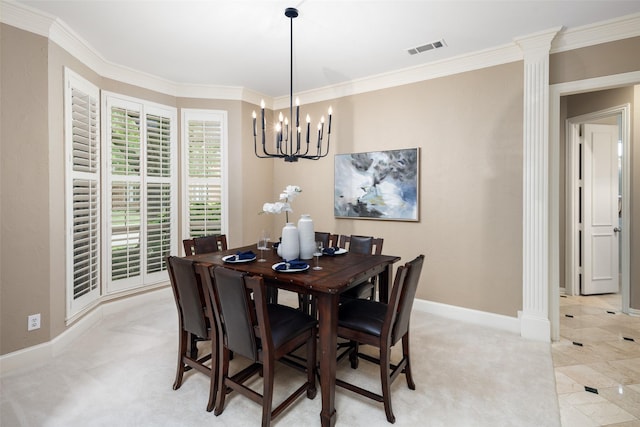 dining area featuring baseboards, a chandelier, ornamental molding, ornate columns, and light colored carpet