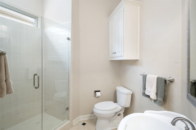 bathroom with a sink, a shower stall, tile patterned floors, and toilet