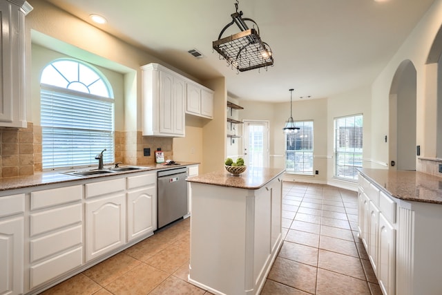 kitchen featuring dishwasher, a sink, a center island, light tile patterned floors, and recessed lighting