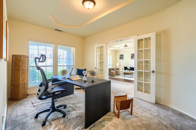 office area with french doors, carpet flooring, and arched walkways
