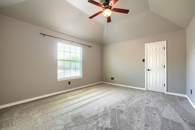 spare room featuring carpet floors, ceiling fan, lofted ceiling, and baseboards