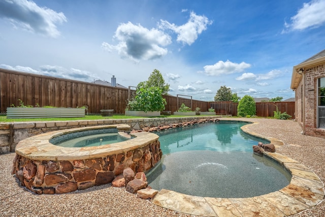 view of swimming pool featuring a pool with connected hot tub and a fenced backyard