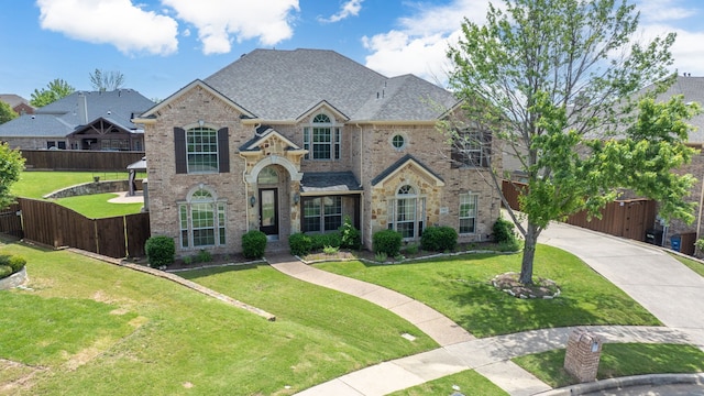 view of front of house featuring brick siding, a gate, concrete driveway, and a shingled roof