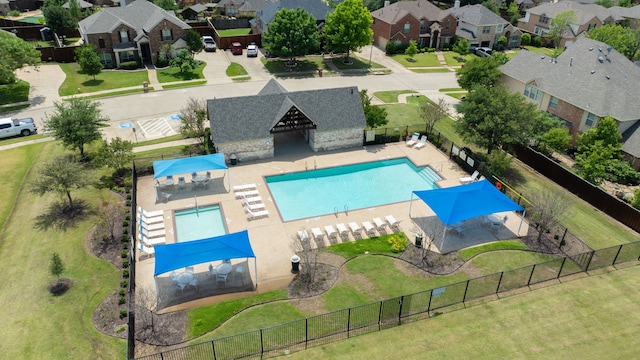 aerial perspective of suburban area featuring a pool
