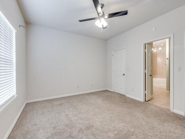 323 Emma Call Ct, Decatur, TX 76234 - empty room with light colored carpet, ceiling fan, a chandelier, and baseboards