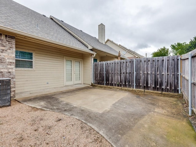 323 Emma Call Ct, Decatur, TX 76234 - view of patio with french doors, a fenced backyard, and central AC