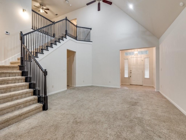 323 Emma Call Ct, Decatur, TX 76234 - unfurnished living room featuring a ceiling fan, stairs, carpet, and high vaulted ceiling