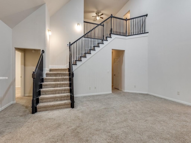 323 Emma Call Ct, Decatur, TX 76234 - stairs with high vaulted ceiling, ceiling fan, carpet flooring, and baseboards