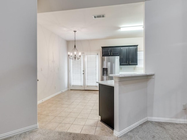 323 Emma Call Ct, Decatur, TX 76234 - kitchen with stainless steel fridge with ice dispenser, light countertops, a chandelier, and baseboards