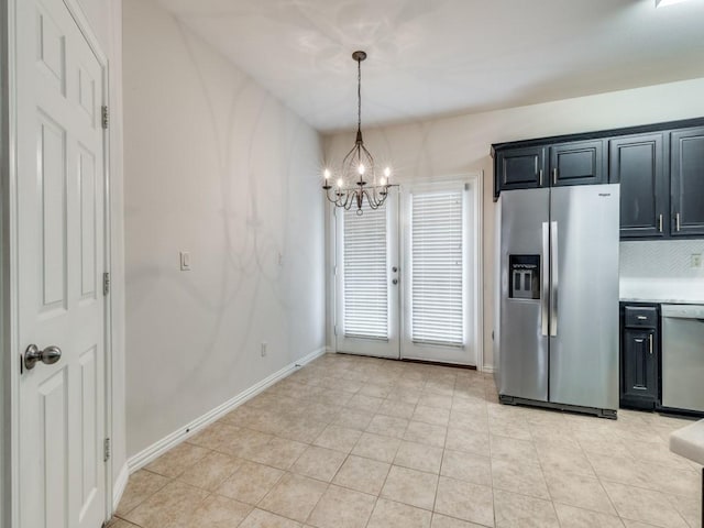 323 Emma Call Ct, Decatur, TX 76234 - kitchen featuring stainless steel appliances, a chandelier, dark cabinets, light countertops, and hanging light fixtures