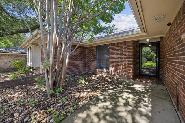 4204 Twilight Dr S, Benbrook, TX 76116 - doorway to property featuring brick siding and a patio area
