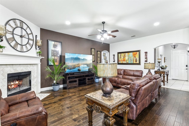 121 Quail Run Rd, Red Oak, TX 75154 - living area featuring arched walkways, a ceiling fan, hardwood / wood-style floors, recessed lighting, and a tiled fireplace