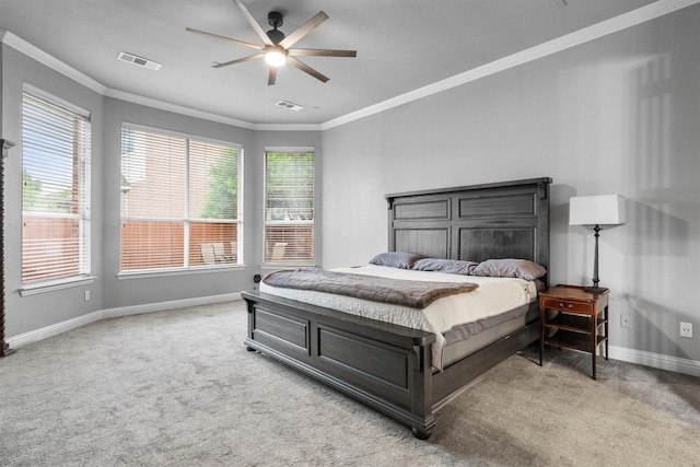 bedroom featuring carpet floors, multiple windows, baseboards, crown molding, and ceiling fan