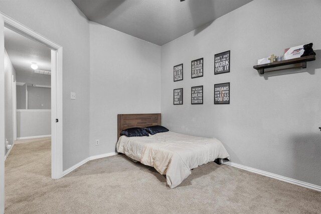 carpeted bedroom featuring baseboards