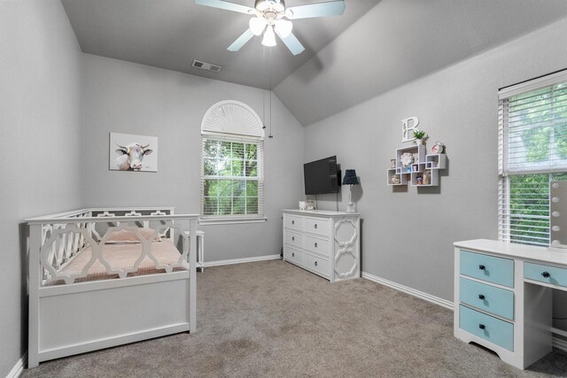 carpeted bedroom featuring lofted ceiling, baseboards, and ceiling fan
