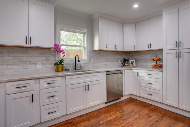 4719 Wateka Dr, Dallas, TX 75209 - kitchen with stainless steel dishwasher, a sink, white cabinets, backsplash, and ornamental molding