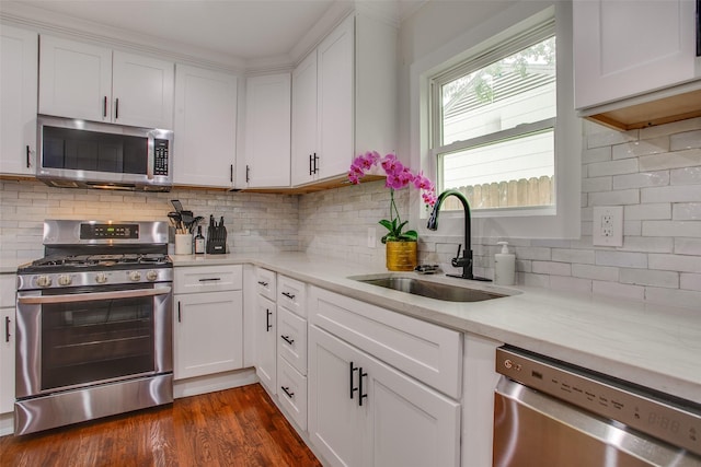 4719 Wateka Dr, Dallas, TX 75209 - kitchen featuring stainless steel appliances, a sink, white cabinetry, and decorative backsplash