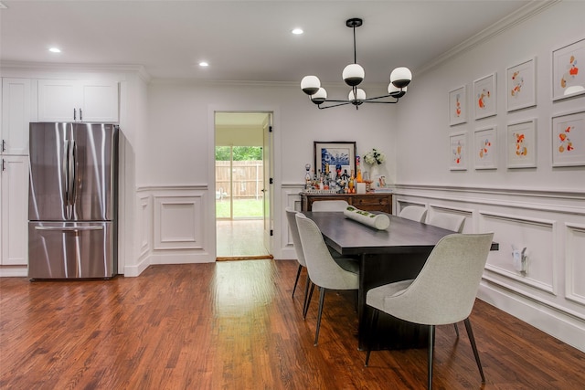 4719 Wateka Dr, Dallas, TX 75209 - dining room with a decorative wall, a chandelier, crown molding, dark wood finished floors, and recessed lighting