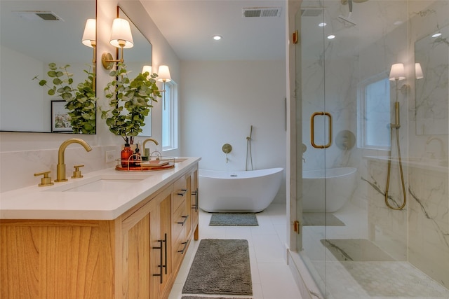 4719 Wateka Dr, Dallas, TX 75209 - bathroom with a marble finish shower, double vanity, a freestanding bath, and tile patterned floors