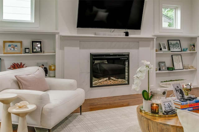 4719 Wateka Dr, Dallas, TX 75209 - sitting room with a fireplace, built in shelves, and wood finished floors