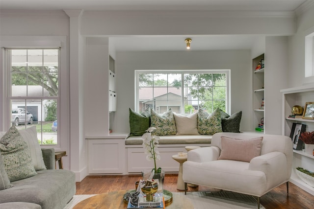 4719 Wateka Dr, Dallas, TX 75209 - living area with light wood finished floors, ornamental molding, and built in shelves