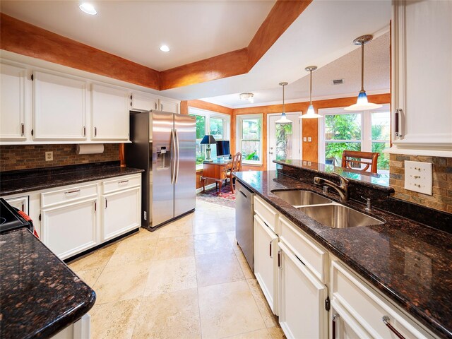kitchen with appliances with stainless steel finishes, a sink, tasteful backsplash, white cabinetry, and recessed lighting