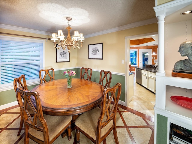 dining room with inlaid floor details, ornamental molding, healthy amount of natural light, baseboards, and a textured ceiling