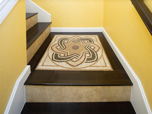 staircase featuring baseboards