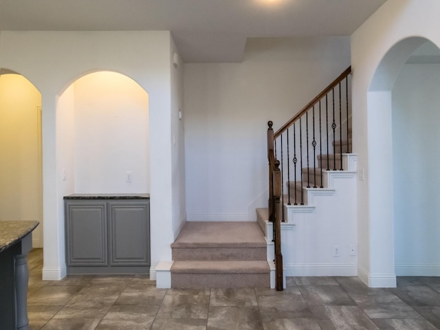 928 Freesia Dr, Little Elm, TX 75068 - staircase with arched walkways and baseboards