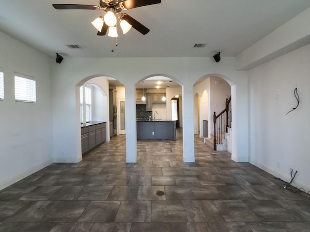 928 Freesia Dr, Little Elm, TX 75068 - unfurnished living room featuring ceiling fan, a sink, baseboards, and stairs