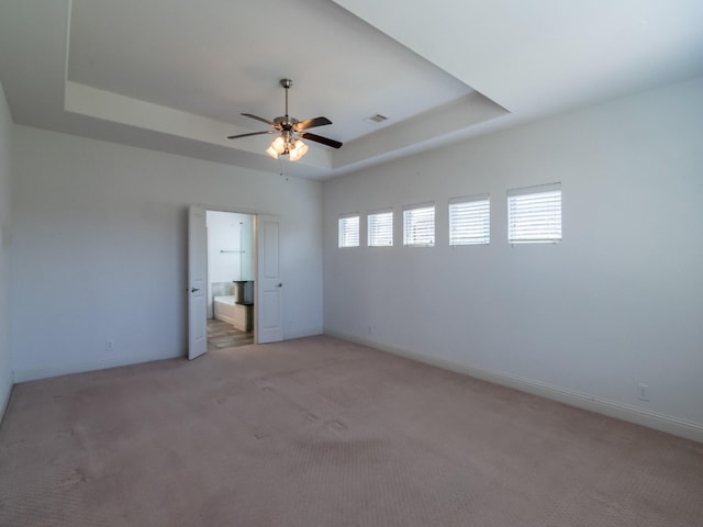928 Freesia Dr, Little Elm, TX 75068 - unfurnished bedroom with a raised ceiling, light carpet, and baseboards