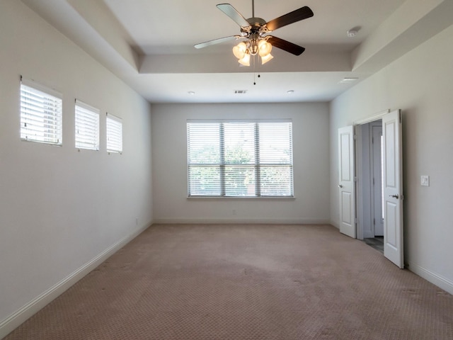 928 Freesia Dr, Little Elm, TX 75068 - unfurnished bedroom featuring light carpet, baseboards, a ceiling fan, and a raised ceiling