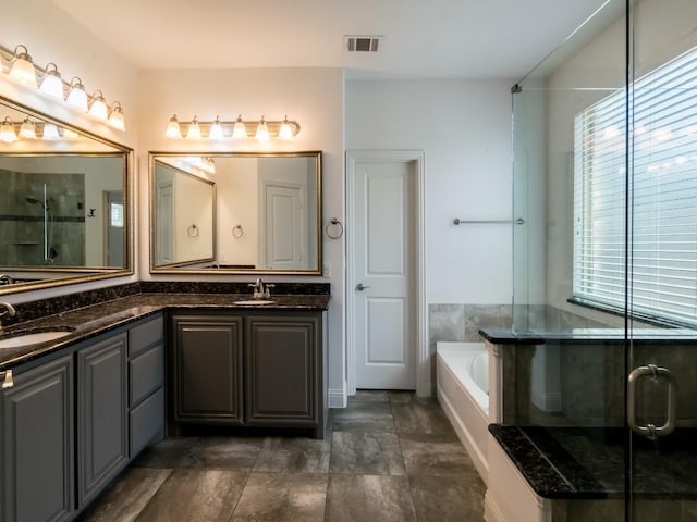 928 Freesia Dr, Little Elm, TX 75068 - bathroom with double vanity, a shower stall, and a garden tub
