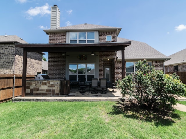 928 Freesia Dr, Little Elm, TX 75068 - back of house featuring brick siding, exterior kitchen, a patio, a chimney, and a shingled roof