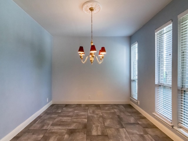 928 Freesia Dr, Little Elm, TX 75068 - unfurnished dining area featuring a chandelier, plenty of natural light, and baseboards