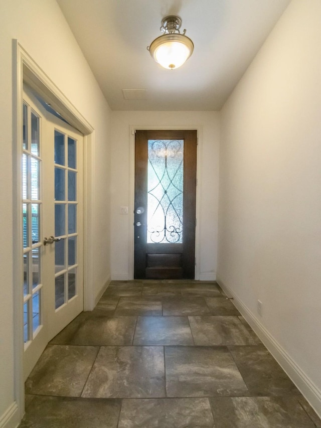 928 Freesia Dr, Little Elm, TX 75068 - foyer featuring stone finish flooring, baseboards, and french doors
